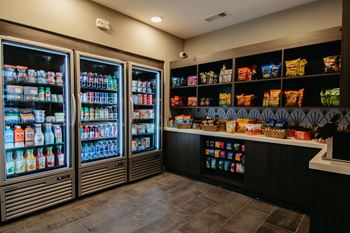 a convenience store with a large display of drinks and snacks